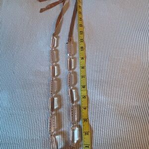 J. Crew,Clear pink hued with  Brown tie ribbon Necklace.